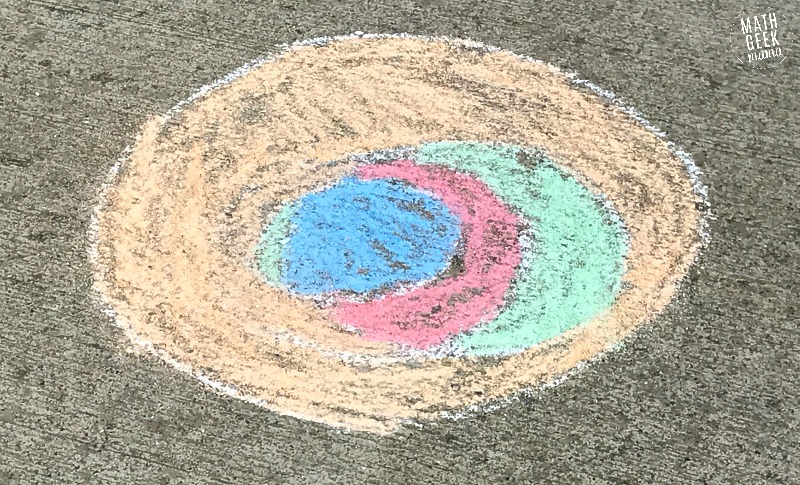 Looking for a fun, yet super simple way to engage your kids this Pi Day? This Pi Day art project is just as fun with paper and colored pencils as it is with sidewalk chalk! Learn more and get a free printable recording page in the full post!